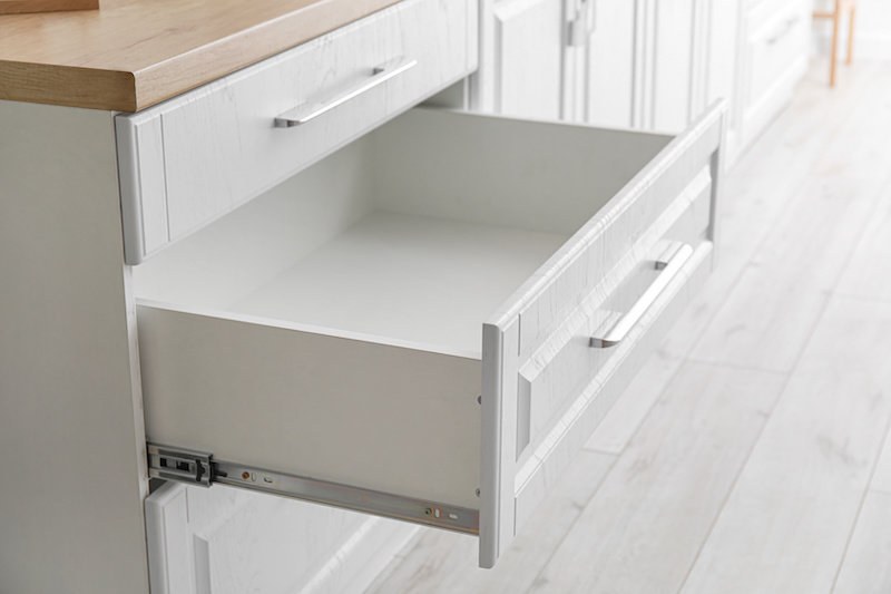 Open, empty kitchen drawer with clean interior surfaces